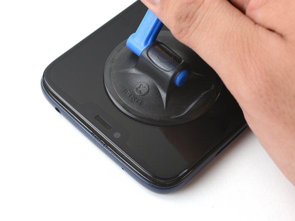 Pull up on the suction cup with strong, steady force to create a gap.