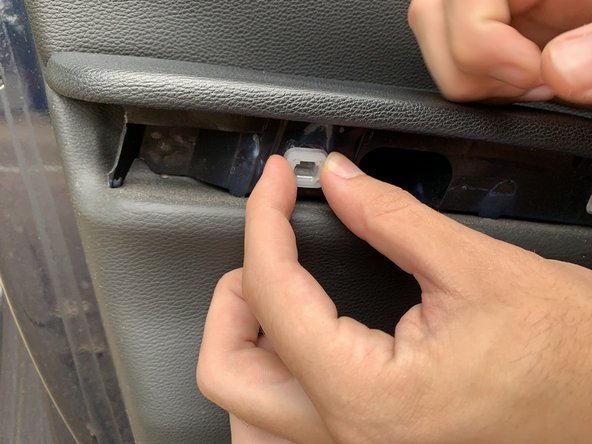 If any of the plastic clips come loose with the trim, remove them and press them back into the door panel.