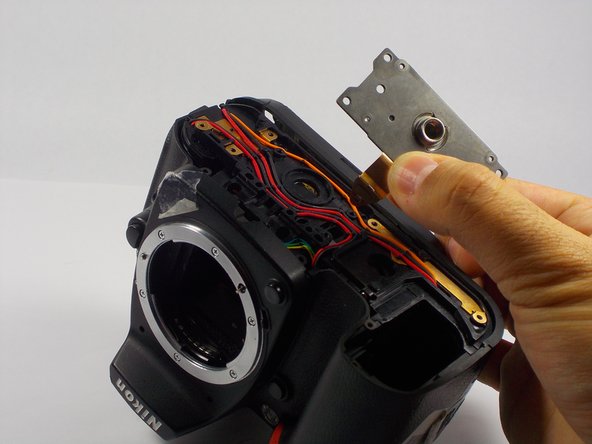 Nikon D90 Tripod Thread Plate Replacement, Removing the Plate from the Camera: crwdns2935265:06crwdnd2935265:02crwdnd2935265:02crwdne2935265:0