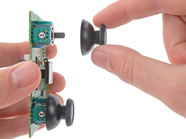 DualSense Controller v2 Joystick Replacement, Remove the joystick covers: crwdns2935265:027crwdnd2935265:02crwdnd2935265:03crwdne2935265:0