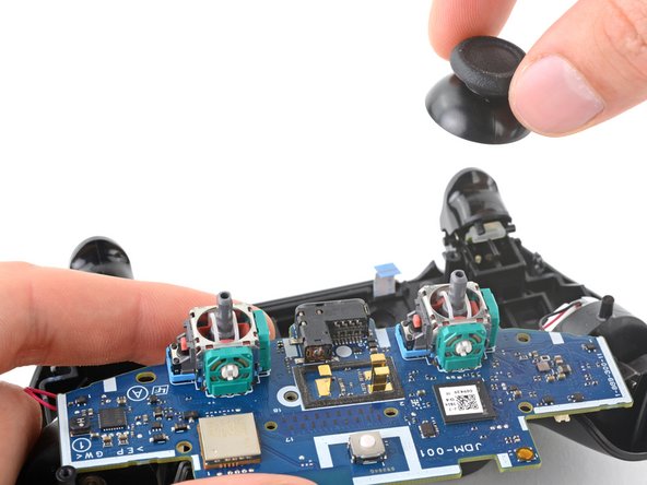 DualShock 4 (CUH-ZCT1U) Analog Stick Covers Replacement, Remove the analog stick covers: crwdns2935265:021crwdnd2935265:03crwdnd2935265:03crwdne2935265:0
