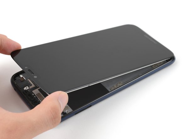 Grasp the top edge of the screen and lift it up to loosen it from the frame.