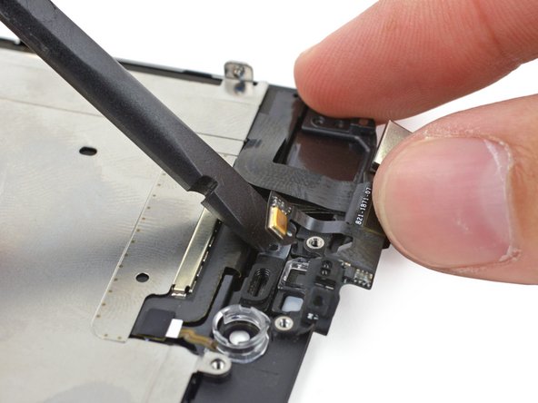Carefully pry the microphone end of the sensor cable off of the adhesive holding it to the front panel.