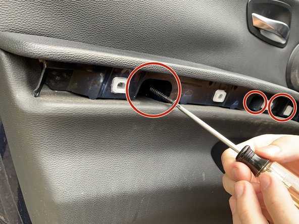 Using a T20 Torx, remove the three screws located behind the previously removed trim.