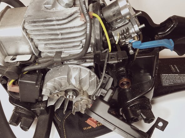 Using a flat head screw driver disconnect the (primer-side) fuel line from the carburetor.