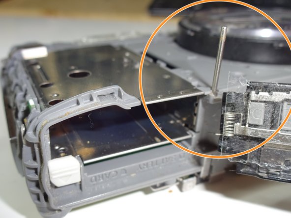 Panasonic DMC-ZS8 Digital Camera Door Replacement, Inserting Rod: step 5, image 1 of 2