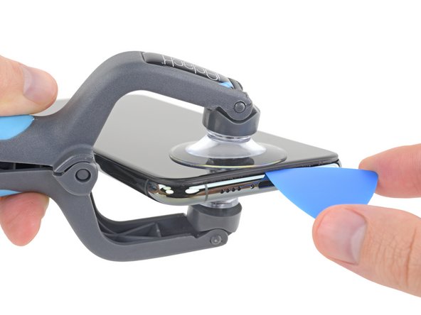 Insert an opening pick into the gap under the display on the lower edge of the iPhone.