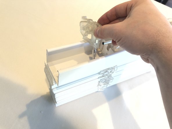 Remove the tilt wand mechanism by sliding it off the center rod.