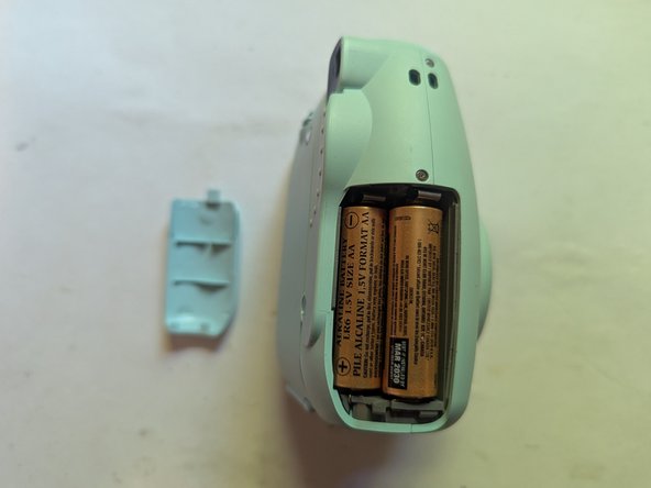 Fujifilm Instax Mini 9 Camera Shell Replacement, Remove the Batteries: crwdns2935265:03crwdnd2935265:03crwdnd2935265:03crwdne2935265:0