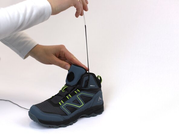 How to Replace a Dial-Lace System in a Hiking Boot, Remove the lace from the metal loop: crwdns2935265:08crwdnd2935265:02crwdnd2935265:03crwdne2935265:0