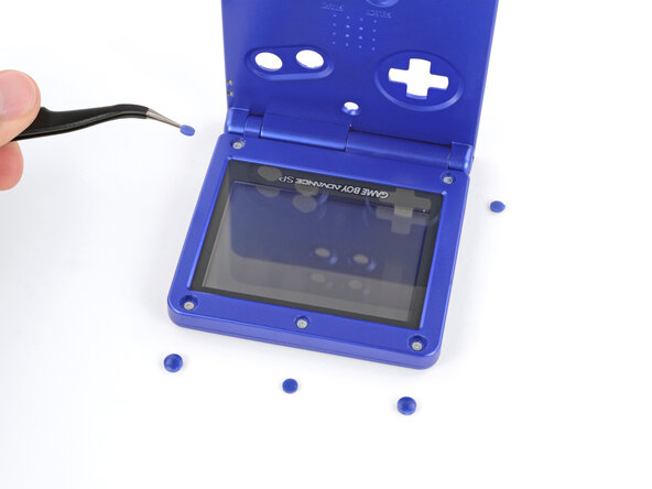How to Reshell Your Game Boy Advance SP, Remove the rubber screw covers: crwdns2935265:019crwdnd2935265:03crwdnd2935265:03crwdne2935265:0