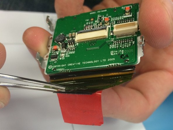 Creative Zen Microphoto Screen Replacement, Detaching the Red Strip from the Back of the Screen: crwdns2935265:016crwdnd2935265:02crwdnd2935265:02crwdne2935265:0