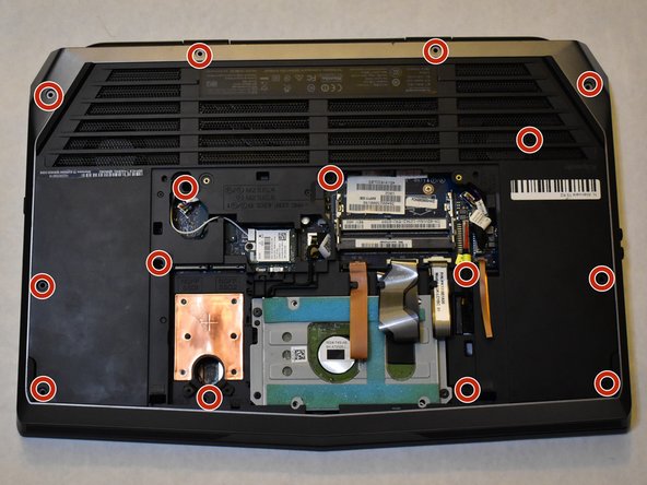 Press your finger in the hole next to the hard drive to lift the keyboard up.