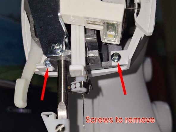Disassembling Sewing Machine Singer M2605, Cover left hand edge screws: step 6, image 1 of 1