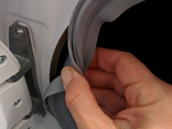 Washing Machine Disassembly to Access Water Drain Pump, Detach door seal from front cover: step 7, image 2 of 3