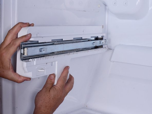 LG Refrigerator Evaporator Fan Replacement, Release lower left drawer slide and reposition it: crwdns2935265:010crwdnd2935265:02crwdnd2935265:03crwdne2935265:0