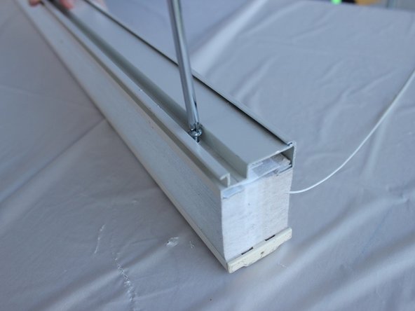 Take out the screw using the phillips screwdriver and slide the top rail off.