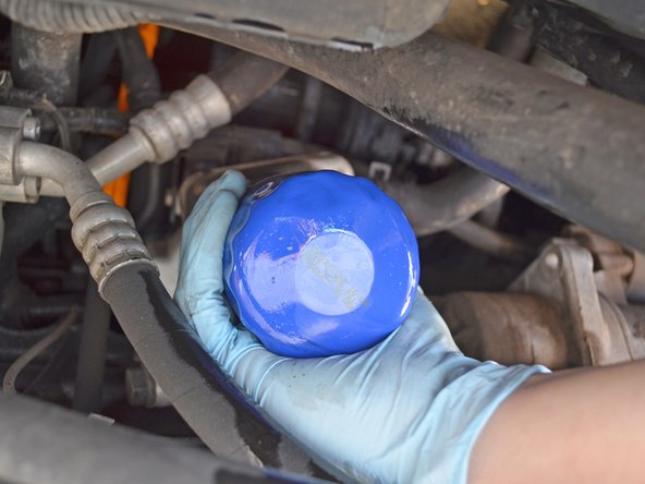 Be sure to use clean gloves to screw in the new filter. Using ones covered in oil will make it extremely hard to grip the filter and could lead to a messy accident.