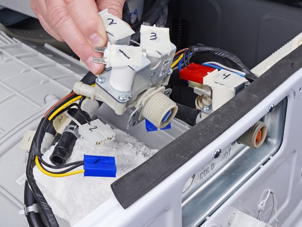 LG WM3050CW Inlet Valve Assembly Replacement, Remove the inlet valve assembly: crwdns2935265:014crwdnd2935265:03crwdnd2935265:03crwdne2935265:0