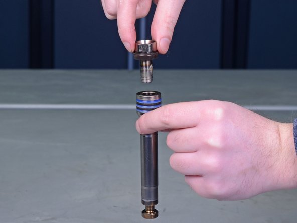 Remove the piston valve bolt from the piston rod.