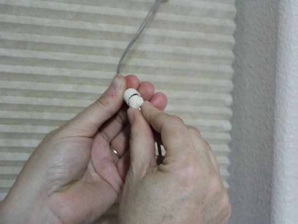 Screw the lower half of the tassel onto the top half.