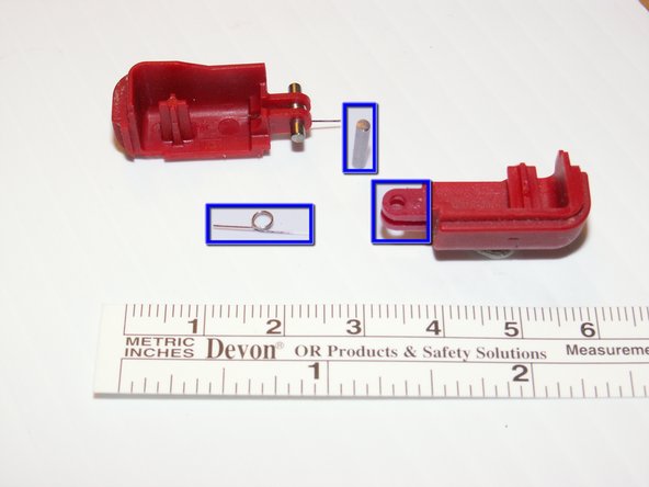 The two shoulder buttons are made up of three pieces -- the plastic button, a pin, and a spring.  If they accidentally pop out while you are working, study the picture and make sure you put the spring in the correct position.