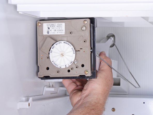 How to Replace the Ice Maker in an Older Whirlpool Refrigerator, Releasing the ice maker: step 9, image 2 of 3