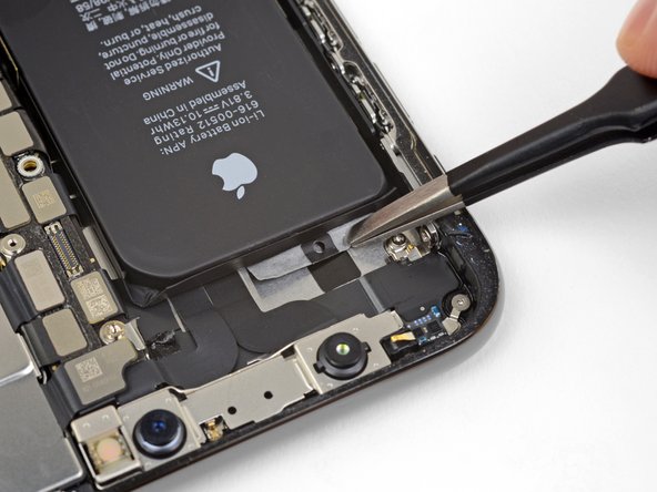 Peel and separate the pull tab on the final adhesive strip, on the top edge of the upper battery cell.