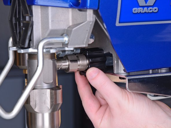 Once unscrewed, push the connector back to reveal the hose connection.