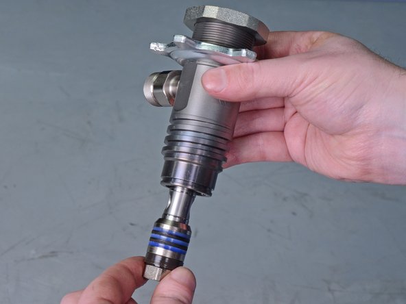 Remove the pump cylinder from the vise and pull the bottom of the piston rod completely out of the pump cylinder to remove it.