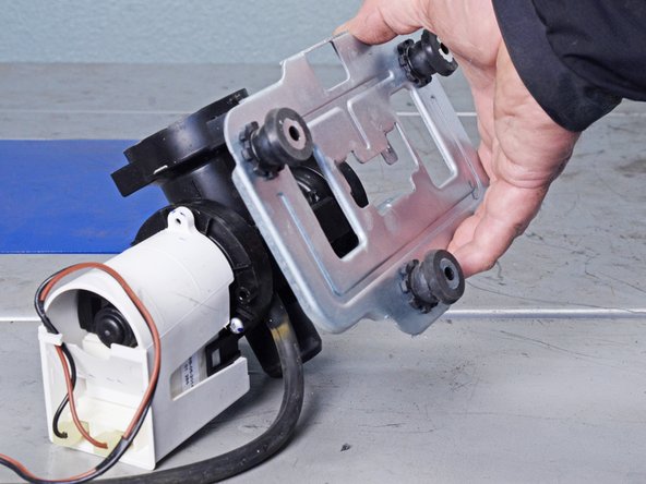 LG Front Load Washing Machine Drain Pump Motor Replacement, Remove the Pump Bracket: crwdns2935265:038crwdnd2935265:02crwdnd2935265:02crwdne2935265:0