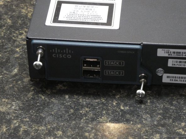Cisco Catalyst 2960-S Series Network Switch Fan Replacement, Remove Stack Module or Blank Cover: crwdns2935265:03crwdnd2935265:02crwdnd2935265:03crwdne2935265:0