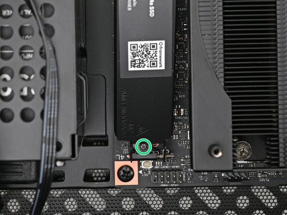 How to Install a Framework Desktop Mainboard Into a Mini‑ITX Case, Remove the primary storage heat spreader screw: step 13, image 2 of 3
