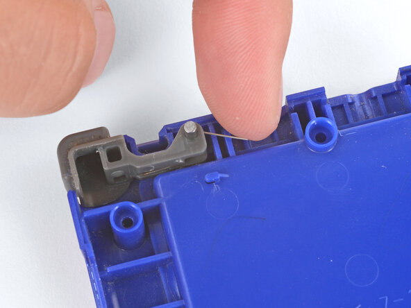 How to Install Shoulder Buttons in Your Game Boy Advance SP, Push the spring arm into place: crwdns2935265:04crwdnd2935265:01crwdnd2935265:02crwdne2935265:0
