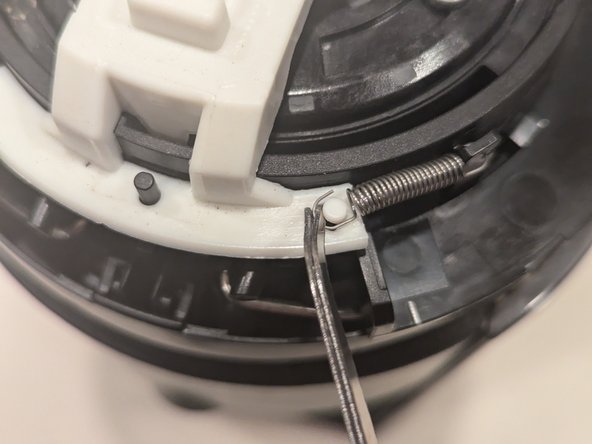 Nespresso Vertuo Evoluo Bearing Replacement, Re-attach lid release spring: crwdns2935265:018crwdnd2935265:02crwdnd2935265:02crwdne2935265:0