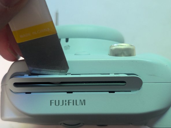 Fujifilm Instax Mini 9 Camera Shell Replacement, Remove the Film Ejection Slot Cover: crwdns2935265:010crwdnd2935265:03crwdnd2935265:03crwdne2935265:0
