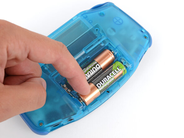 How to Reshell Your Game Boy Advance, Install the batteries: crwdns2935265:036crwdnd2935265:03crwdnd2935265:03crwdne2935265:0
