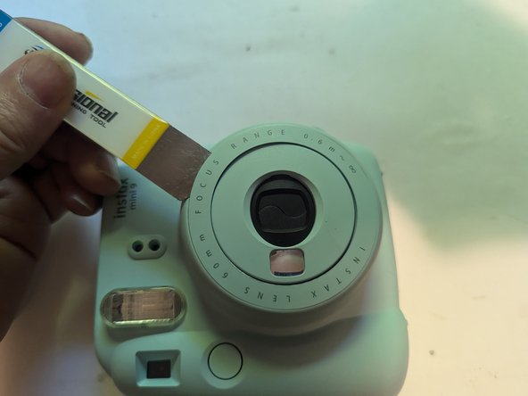 Fujifilm Instax Mini 9 Camera Shell Replacement, Remove the Brightness Adjustment Dial Cover: crwdns2935265:07crwdnd2935265:02crwdnd2935265:03crwdne2935265:0