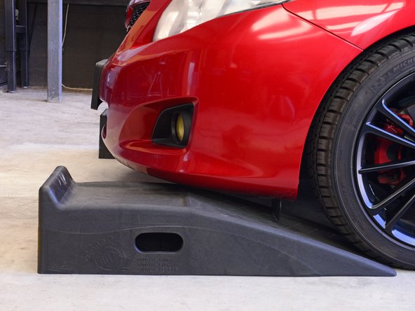 With the motor running and your vehicle in gear, begin slowly driving it straight forward onto the ramps.