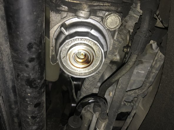 Then insert a ⅜ socket and slowly turn counterclockwise to loosen only the oil filter cap. This will expose the oil filter drain bypass.