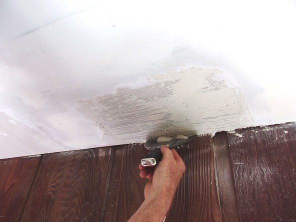 If matching a ceiling with any other texture but popcorn, pat the sanded areas with a lightly dampened sponge and skim a moderately thick layer of joint compound across the entire repair, including the bare areas of the new piece. Feather patches onto the existing ceiling to conceal the lines of repair and let dry before painting. Pic 2.
