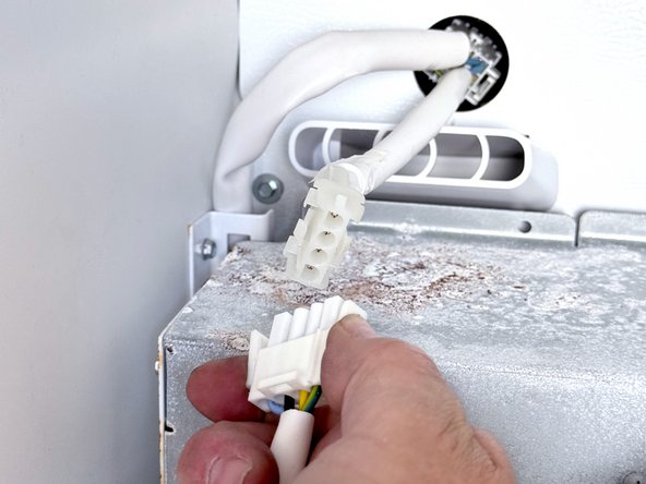 Frigidaire Side-By-Side Refrigerator Evaporator Fan Cover Removal, Disconnect the icemaker: crwdns2935265:05crwdnd2935265:03crwdnd2935265:03crwdne2935265:0