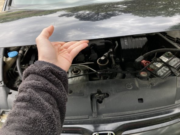 Detach the hood support rod and close the hood of your car.