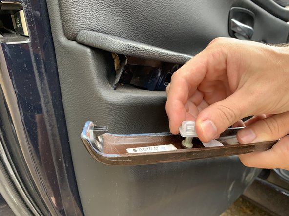 If any of the plastic clips come loose with the trim, remove them and press them back into the door panel.